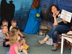 an adult teaching a group of small children